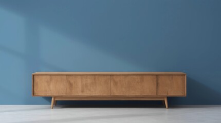 A long wooden cabinet with a rustic finish placed against a matte blue wall