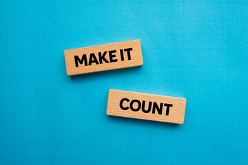 Make it count message written on wooden blocks on blue background. Conceptual make it count symbol. Copy space.