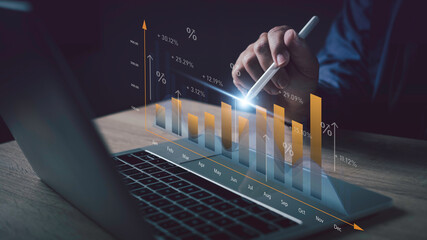 Businessman analyzing return on investment with digital graph showing percentage growth and monthly...