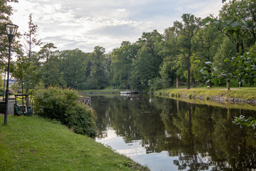 Scenic view of Orebro parks next to the flowing creek surrounded by natural greenery in central Sweden Orebro County