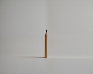 Single Pencil Standing Upright on White Background for Minimalist Design