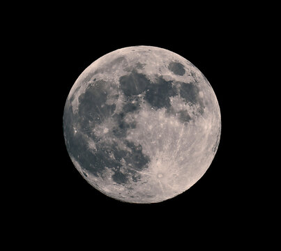 Full moon on night black sky, moon isolated on night sky. Amazing scenery of white glowing moon with craters in black sky on a clear night.