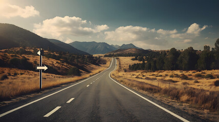 Naklejka premium An empty country road stretching to the mountains with a crossroads sign symbolizing choice, direction, and the journey ahead.