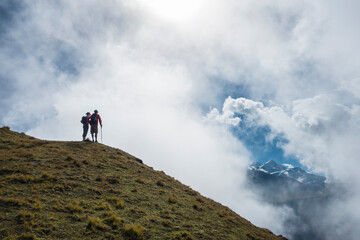 couple trekking to top of mountain with beautiful view.