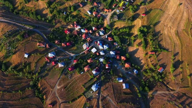 Aerial 4K view of Kurtlu Village, located in Boyabat, Sinop. This peaceful Turkish village, surrounded by golden hills and green trees, reveals traditional rural life from a breathtaking bird&rsquo;s-eye 