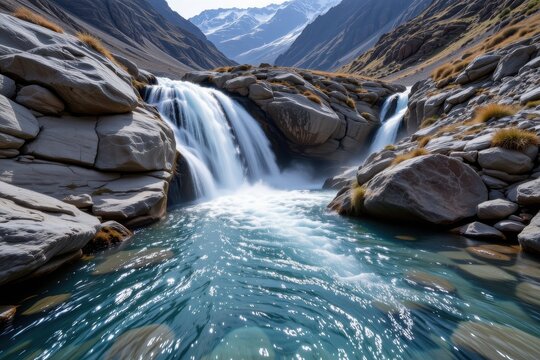 the cold water in glacial waterfalls supports specialized aquatic life adapted to low temperatures creating unique ecosystems found only in glacier influenced environments.