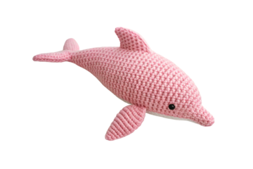 Pink crocheted dolphin toy viewed from different angle showing dorsal fin and flippers, isolated on a transparent background