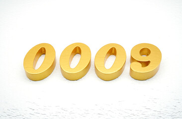 The numbers are made of gold-painted wood, placed on a white background.