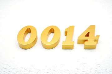 The numbers are made of gold-painted wood, placed on a white background.
