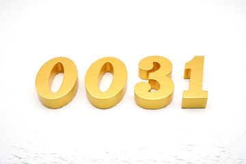 The numbers are made of gold-painted wood, placed on a white background.