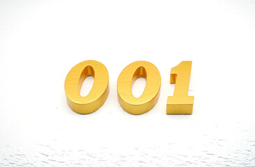 The numbers are made of gold-painted wood, placed on a white background.
