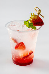 Fresh Strawberry Italian Soda topped with cut strawberry and rosemary leaves,  isolated on white background
