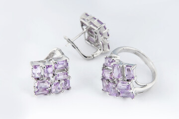 Elegant jewelry set of white gold ring, necklace and earrings with diamonds. Silver jewellery set with gemstones. Product still life concept