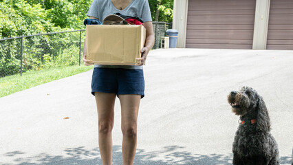 Recycle clothes concept. Cardboard box full of used, discarded items.