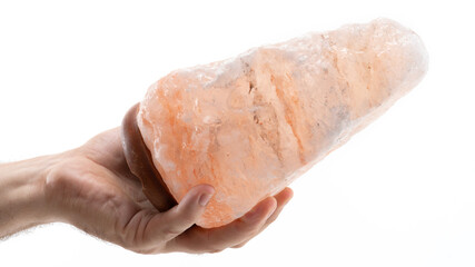 Hand holding a large piece of Himalayan salt