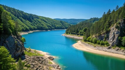 Fototapeta premium Serene turquoise river valley surrounded by lush green forests