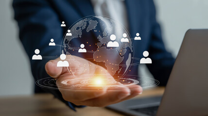 Hand holding digital globe with people icons and glowing light world earth