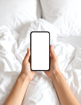 Smartphone held in hands on bed