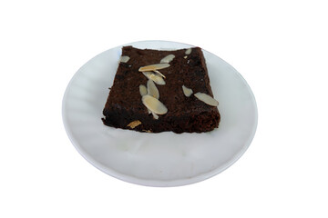Brownie Slice on White Plate With Almond Flakes Garnishing