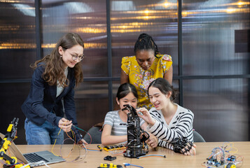 Teacher working with children engineering classroom education stem technology school. Students learning innovation electronic diy robot robot human hand. showcasing creativity and learning.