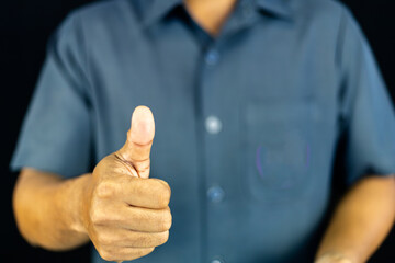  a man in a blue shirt extending his other hand with the palm. This versatile gesture can represent...