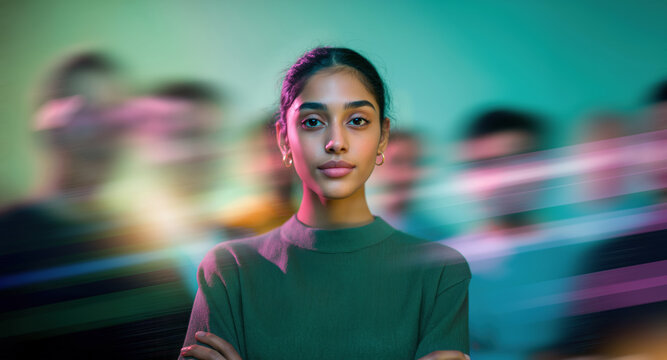 Focused young Indian female leader with her team, facing camera in vibrant teal green and pink motion blur streaks