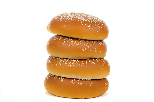 a stack of four sesame buns with sesame seeds