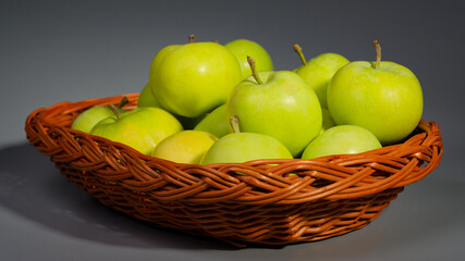 Green summer apples in basket
