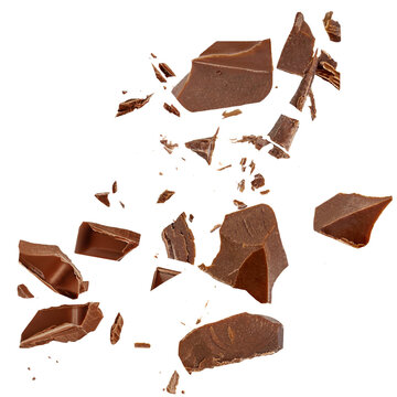 Chocolate explosion isolated on white. Broken chocolate bar pieces flying in the air. Top view. Flat lay. Chocolate levitation&nbsp;with scattered cocoa crumbs
