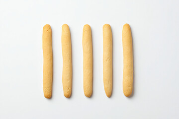 a row of breadsticks sitting on top of a white surface