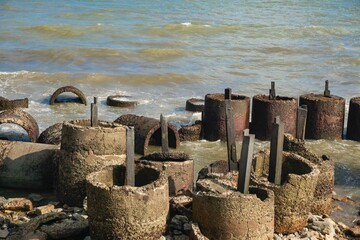 Concrete Breakwaters on a Rocky Shore with Calm Tropical Sea and Blue Sky in Balikpapan, East Borneo