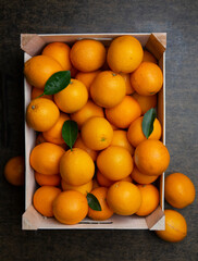 Box filled with oranges. 