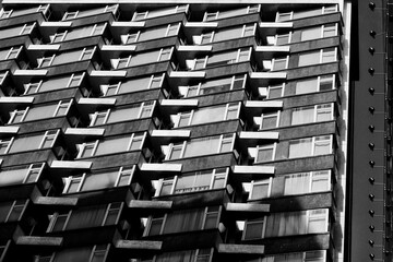 Geometric Repetition and Light Play on Modernist High-Rise Architecture Captured in Striking Black and White Urban Perspective Photography