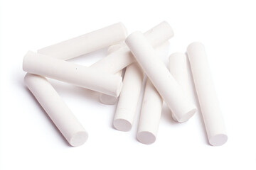 a pile of white plastic tubes on a white surface