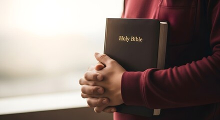 Holy bible study guide and prayer book for christian faith with hands holding bible close up view