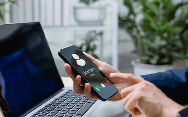 Businessman receiving scam or spam alerts on smartphone. Red warning symbols indicate spam calls and cyber fraud, emphasizing the importance of digital privacy and online security.