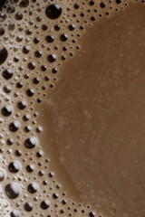 Macro of hot coffee drink texture, coffee foam with bubbles in the background. Top view, coffee cream texture with fragrant coffee background, bubble banner design.
