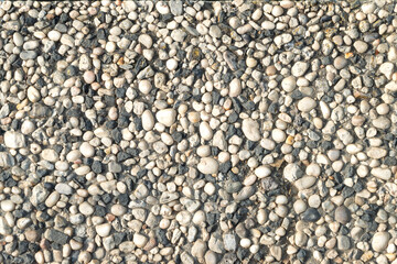 textured background of crushed pebbles or gravel of natural rocks of gray and white colors