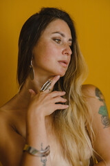 Naked girl with long hair wearing jewelry