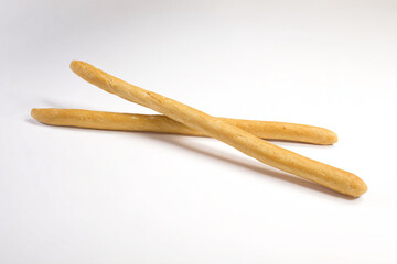 two sticks of bread on a white surface