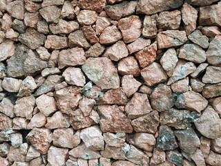 dry stone wall, a type of wall constructed without the use of mortar or cement to bind the stones together. careful selection and interlocking of stones to create a stable structure