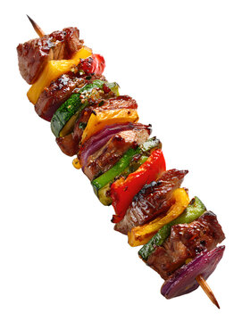 grilled shashlik meat on wooden skewer with vegetables on transparent background