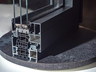 Cross-section of modern aluminum window profile with triple glazing and insulation. Construction,...