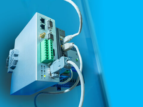 Close-up of industrial control module with connected cables and ports. Automation, electronics, smart systems, IoT, engineering, data transmission, industry 4.0. - Powered by Adobe