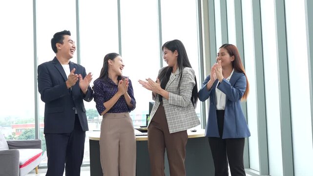 Asian entrepreneur group collaborates in office, fostering teamwork and cooperation to achieve their startup objectives. Their positive partnership drives success, creating a happy and successful job