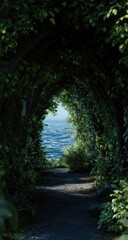 Naklejka premium A pathway through lush foliage leads to a distant, hazy ocean