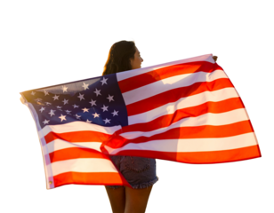 Beautiful patriotic young woman with the American flag held in her standing in the su
