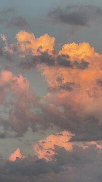 Vertical video. Tenfold acceleration. A passenger plane flies in the distance against a backdrop of pink clouds at dawn. Mallorca Island. Spain.