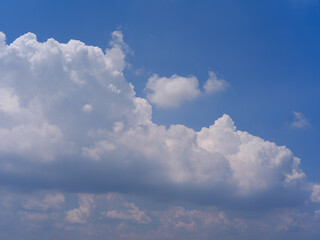 White Fluffy Cumulus Clouds in Clear Blue Summer Sky