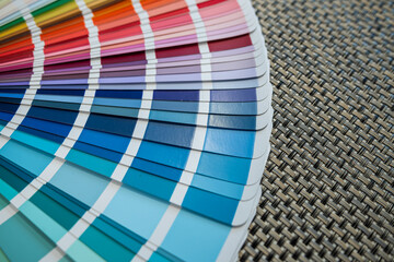 Obraz premium Multicolored paint swatches arranged on black woven surface for color selection concepts